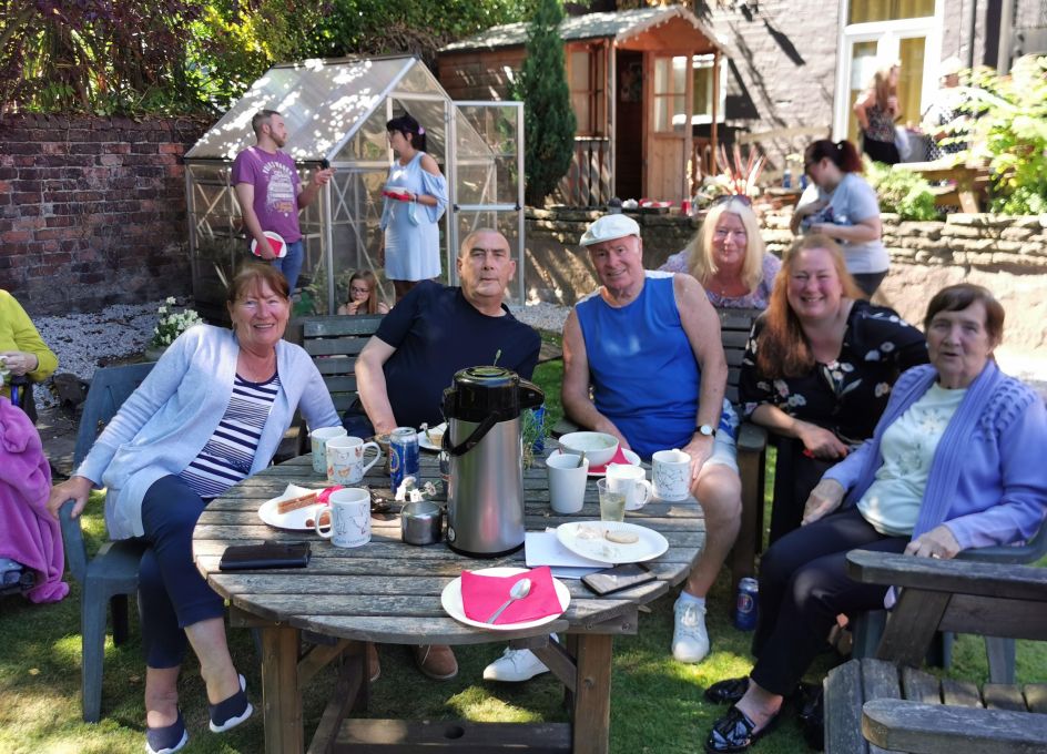 Group of people sitting in a garden